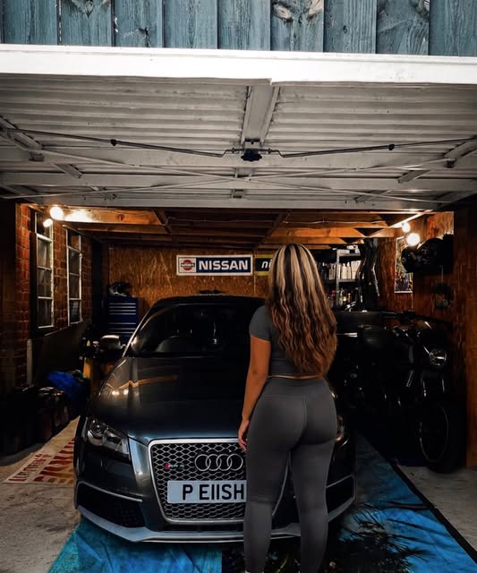 Elisha posing with an Audi in a public Instagram photograph