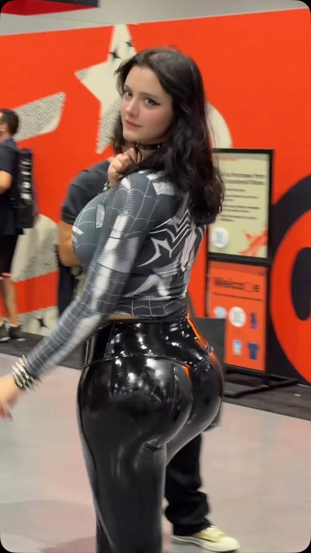 Athena Kami in a black spider-inspired cosplay at a convention